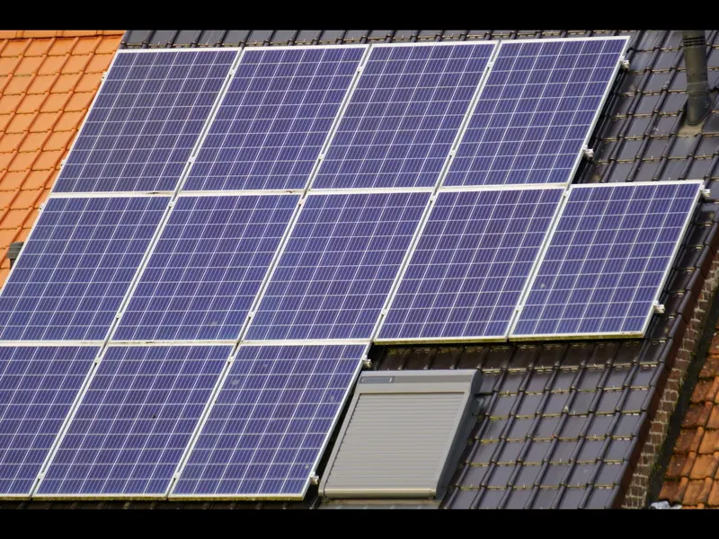Solar panels mounted on the tile roof of a house